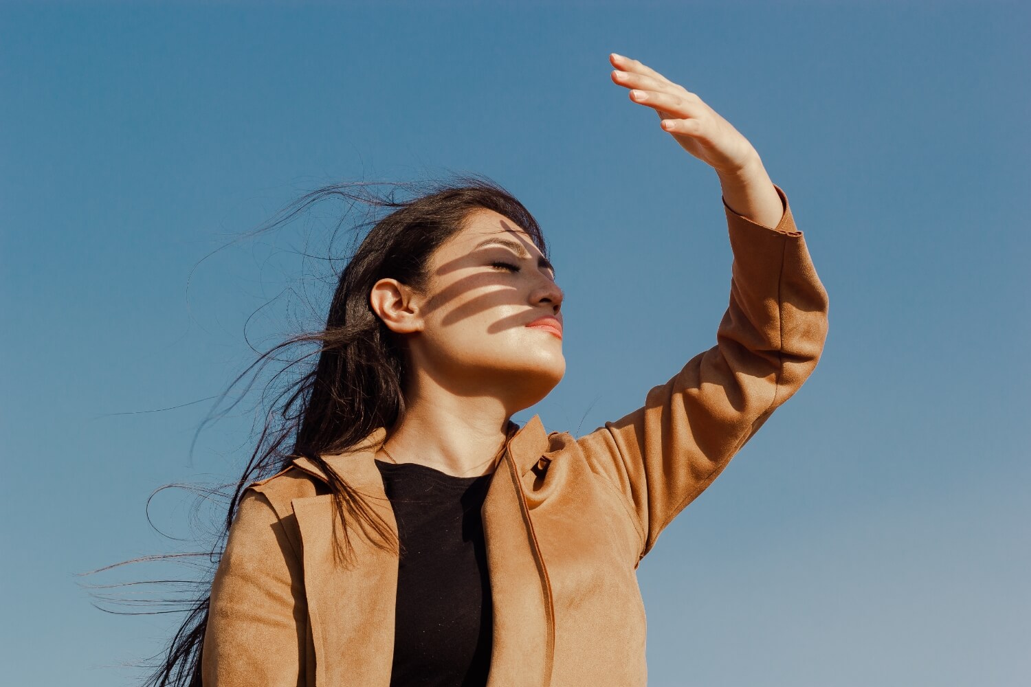 Low angle view young woman standing against clear sky (1)